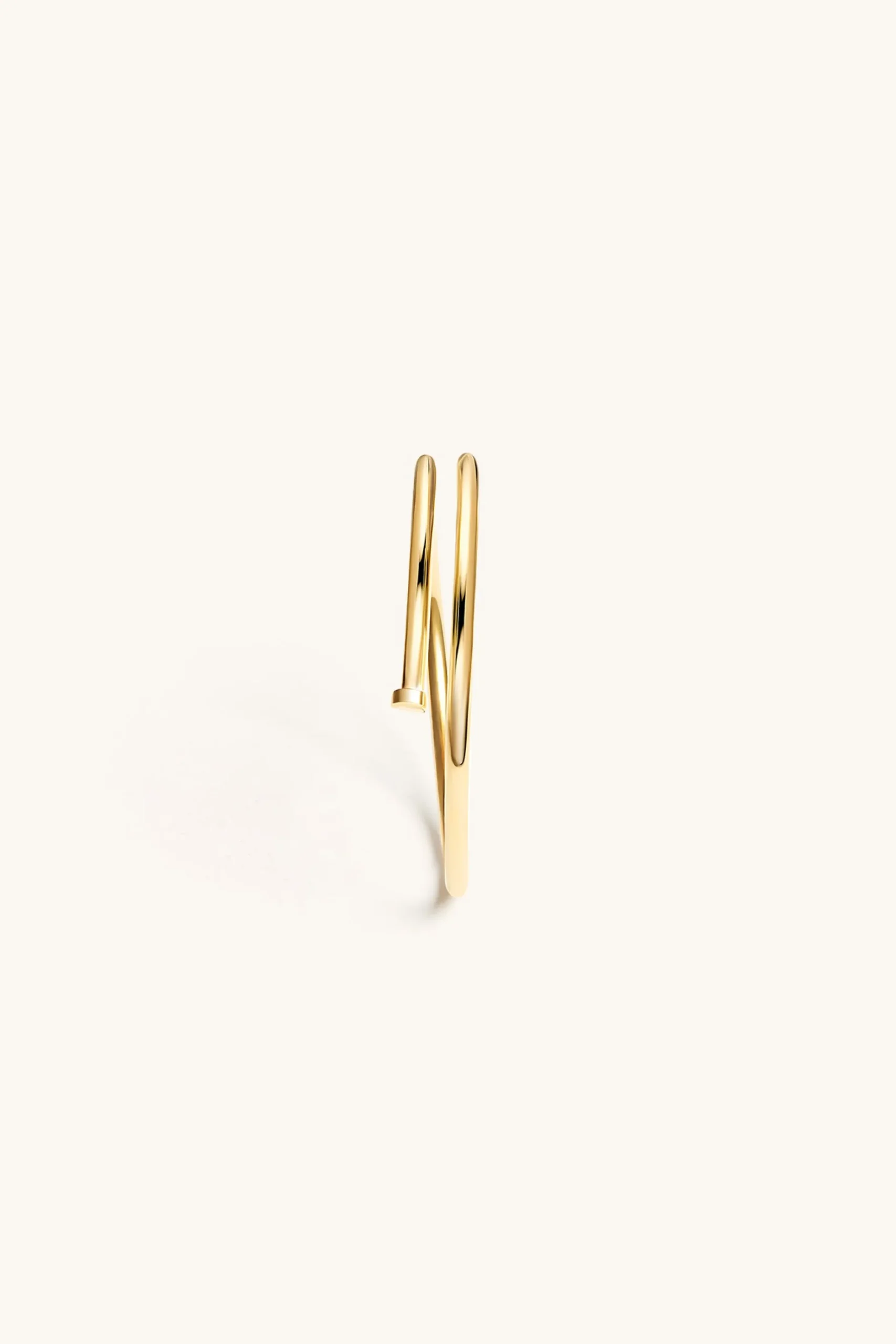 twisted_nail_bangle_kt_go_1.webp 18Kt Gold Plated | Jewellery-BLANK SPACE. TWISTED NAIL BANGLE 18KT GOLD